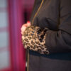 Leopard fur sleeves on womans black coat