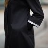Reflective attached sleeves on female coat